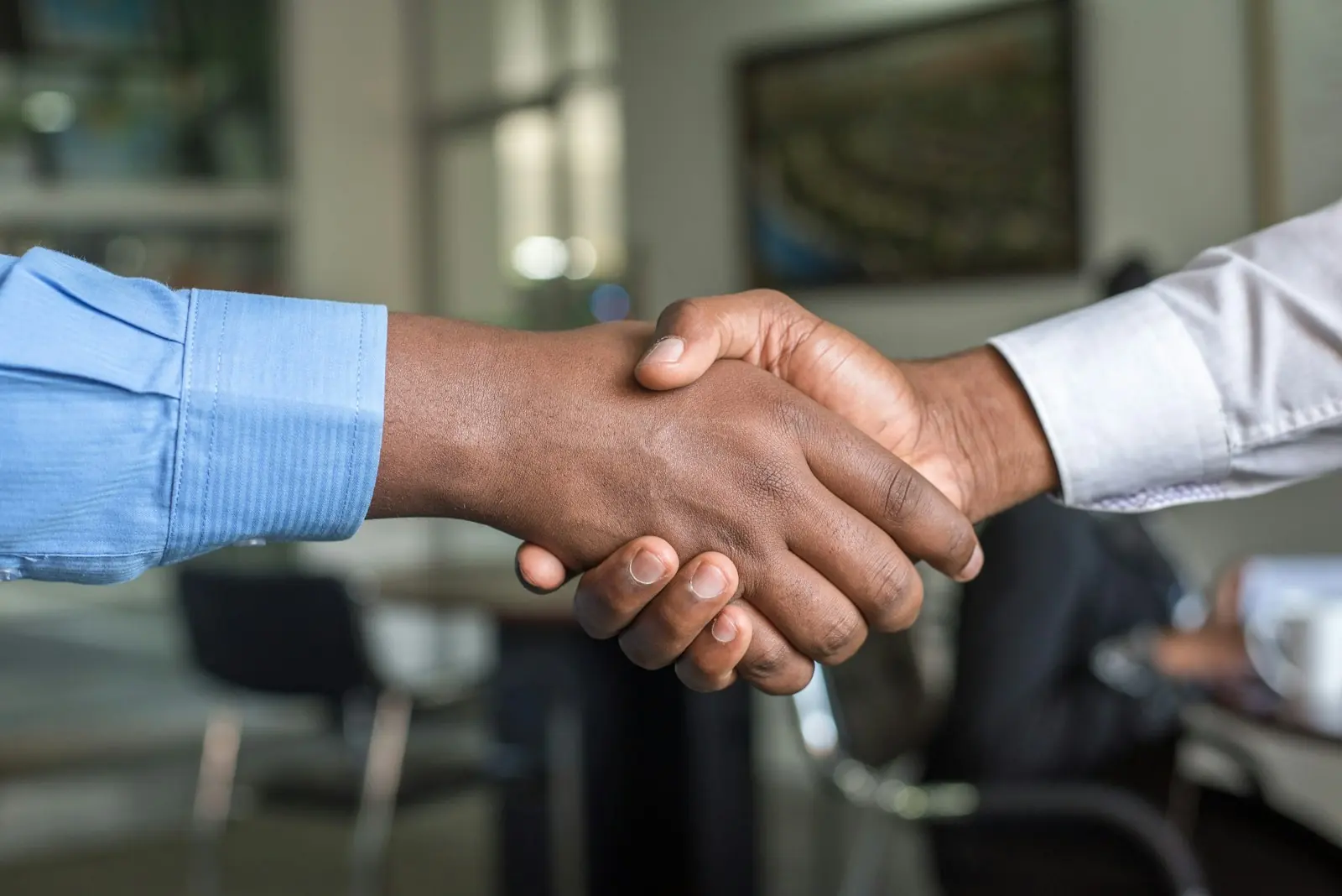 A handshake across a desk