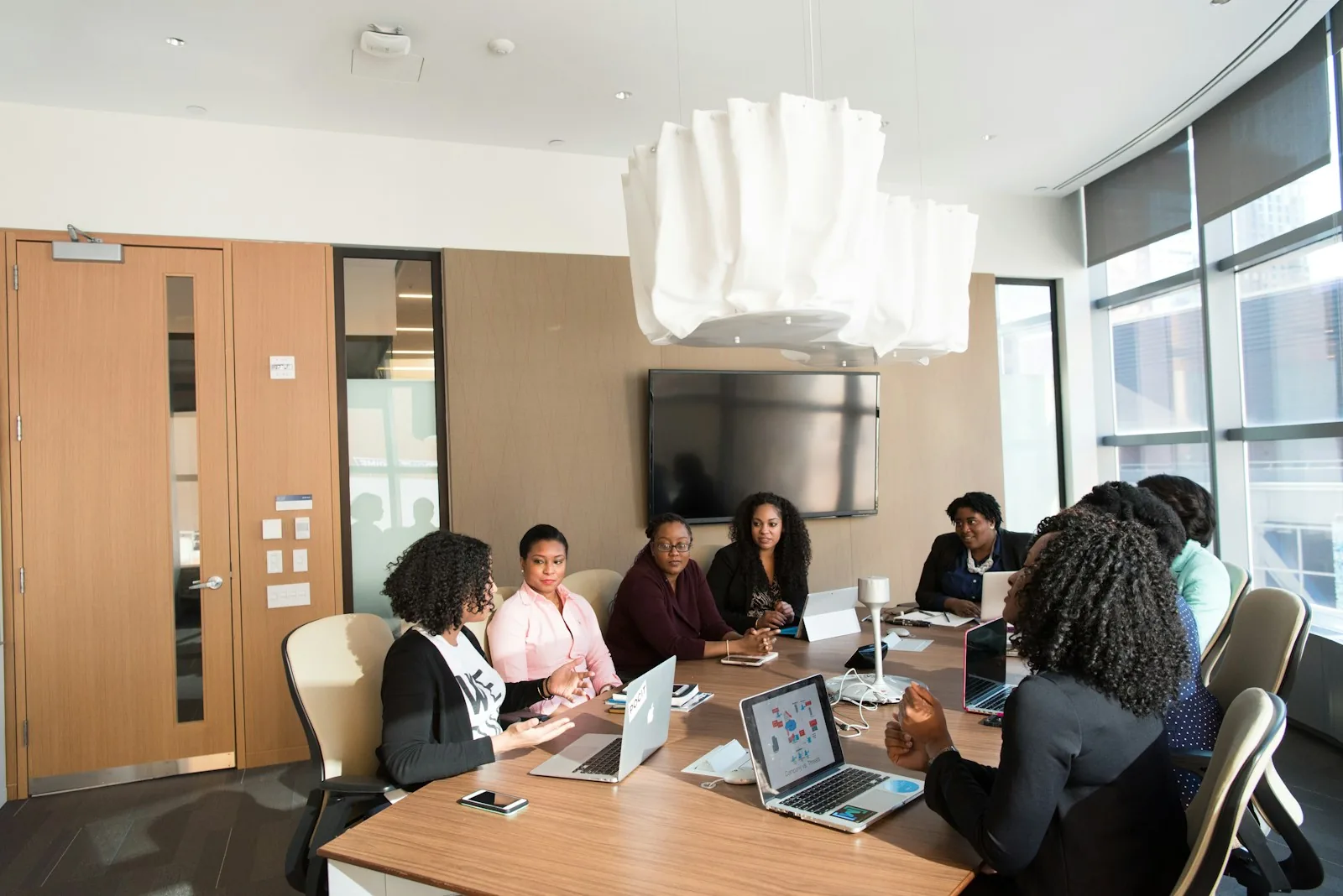 Colleagues in discussion around a boardroom table