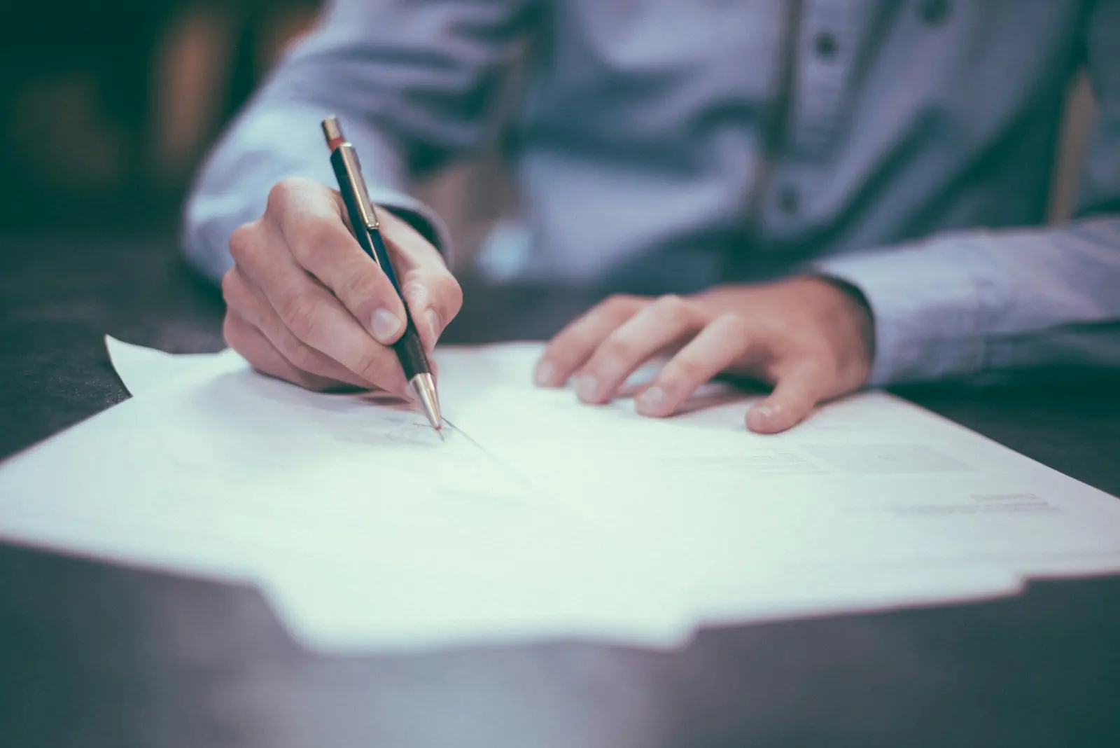 Signing legal documents with a pen